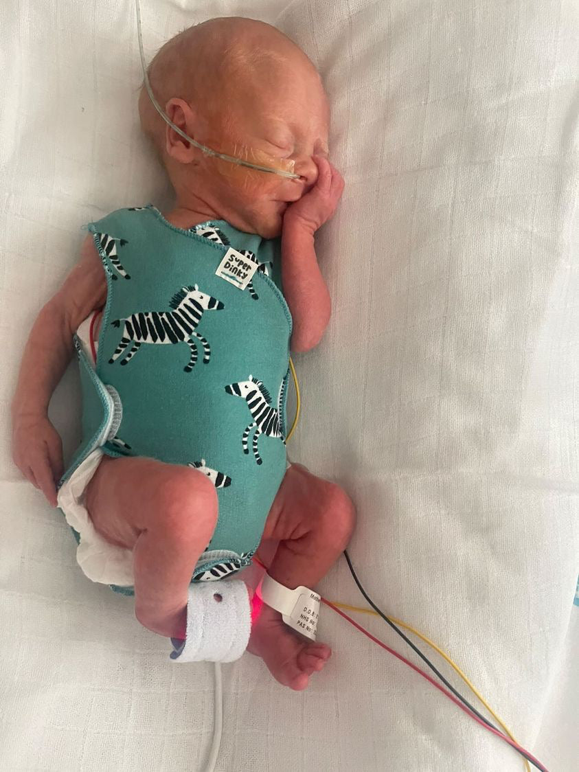 premature baby wearing zebra nicu vest